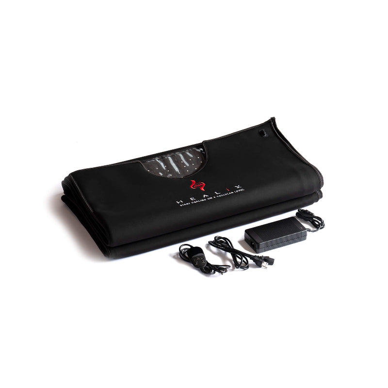 Black mat with a power adapter and cable on a white background