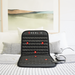 Healix massage mat on a bed with a scenic painting in the background