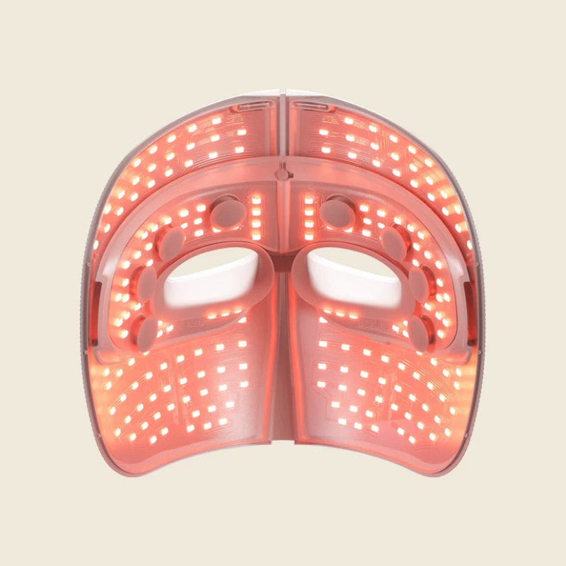 Pink LED face mask on a beige background