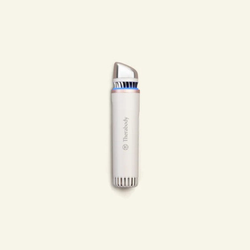 White electronic device with silver top on a beige background