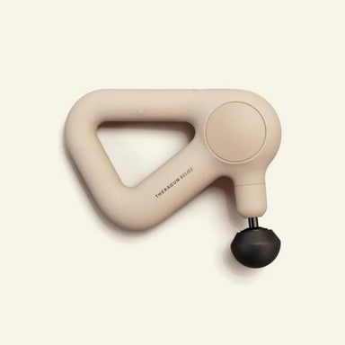 Beige handheld massager on a light beige background