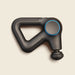 Black handheld massage gun on a beige background