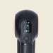 Black handheld device with digital display on a beige background