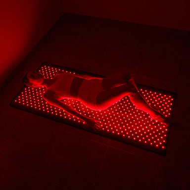 nushape red light therapy mat girl laying down