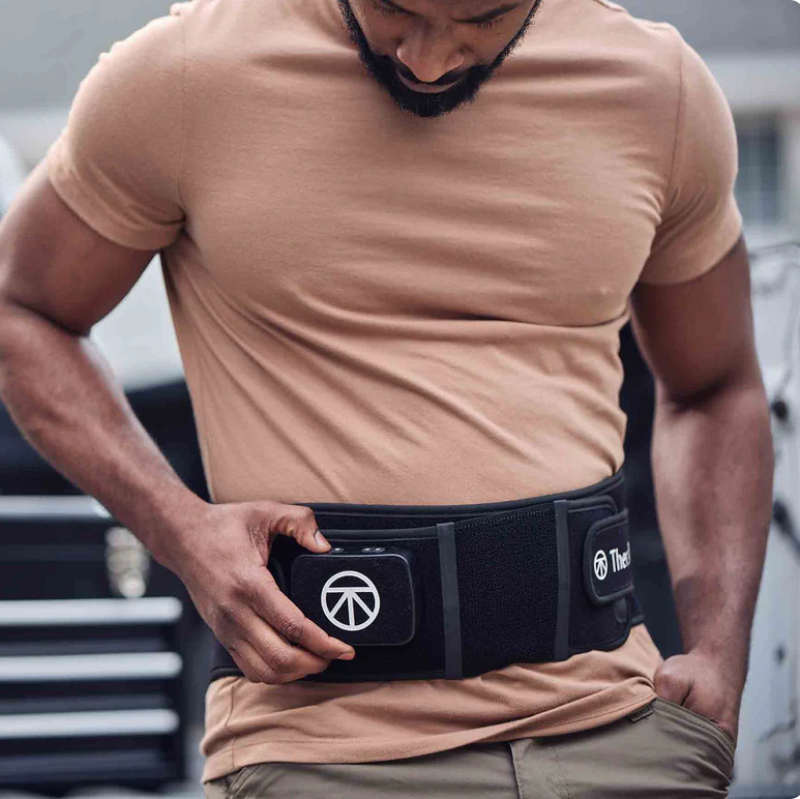 Man wearing a black waist trainer with a visible brand logo.