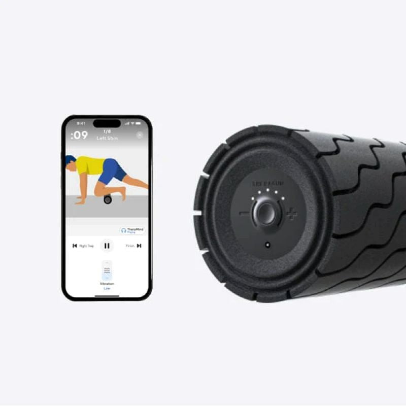 Foam roller next to a smartphone displaying a fitness app on a white background