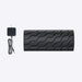 Black foam roller with wave pattern and black attachments on a white background