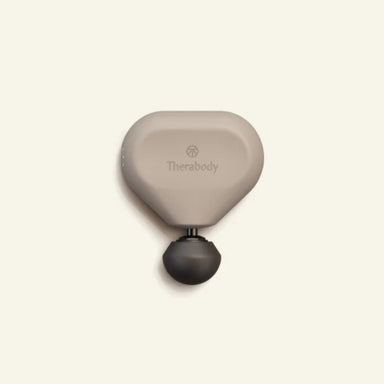 Massage tool with 'Therabody' branding on a beige background